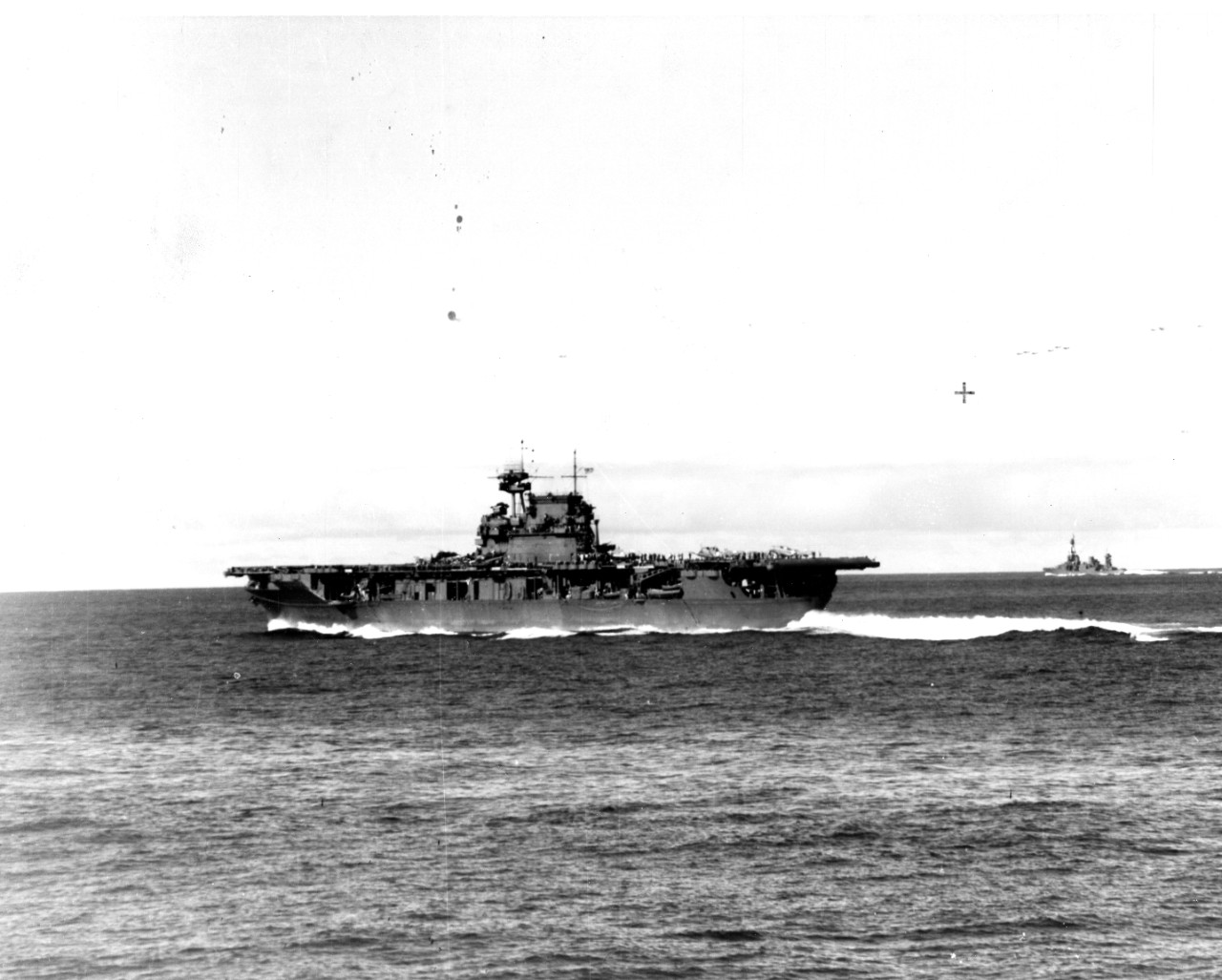 A sailor on board Pensacola snaps this picture of Enterprise as she steams at high speed during the Battle of Midway, at about 0725 on 4 June 1942. The carrier has just launched Dauntlesses of VB-6 and VS-6, and is striking her unlaunched bombers...