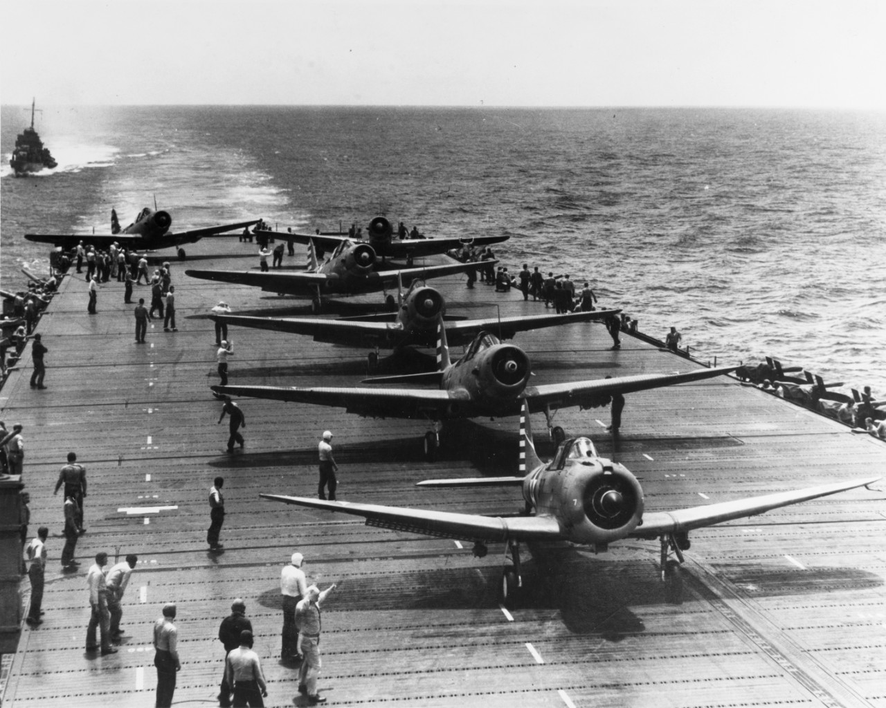 An SBD Dauntless and five TBD-1 Devastators of VT-6 prepare to take off from the ship as she steams southward through a calm sea, 4 May 1942. The launching officer signals the pilots by hand (lower left). (U.S. Navy Photograph 80-G-10151, Nationa...
