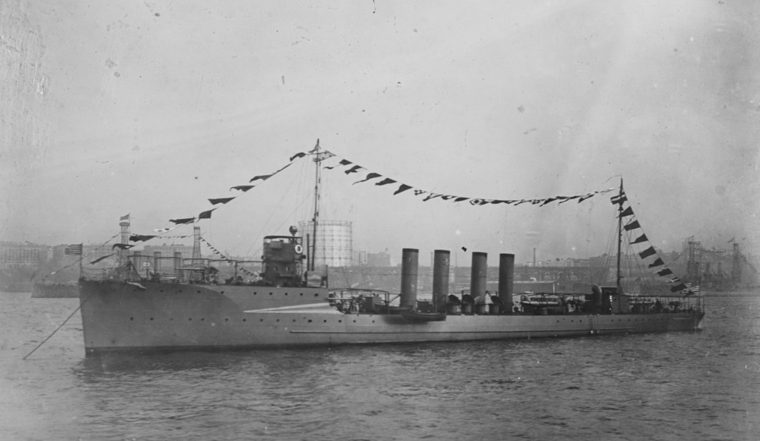 The symbol of her unit assignment (the number Five – for the Fifth Division) affixed to her second stack, Fanning lies at anchor “dressed” overall with signal flags during the Naval Review held in New York in October 1912. Two battleships, displa...
