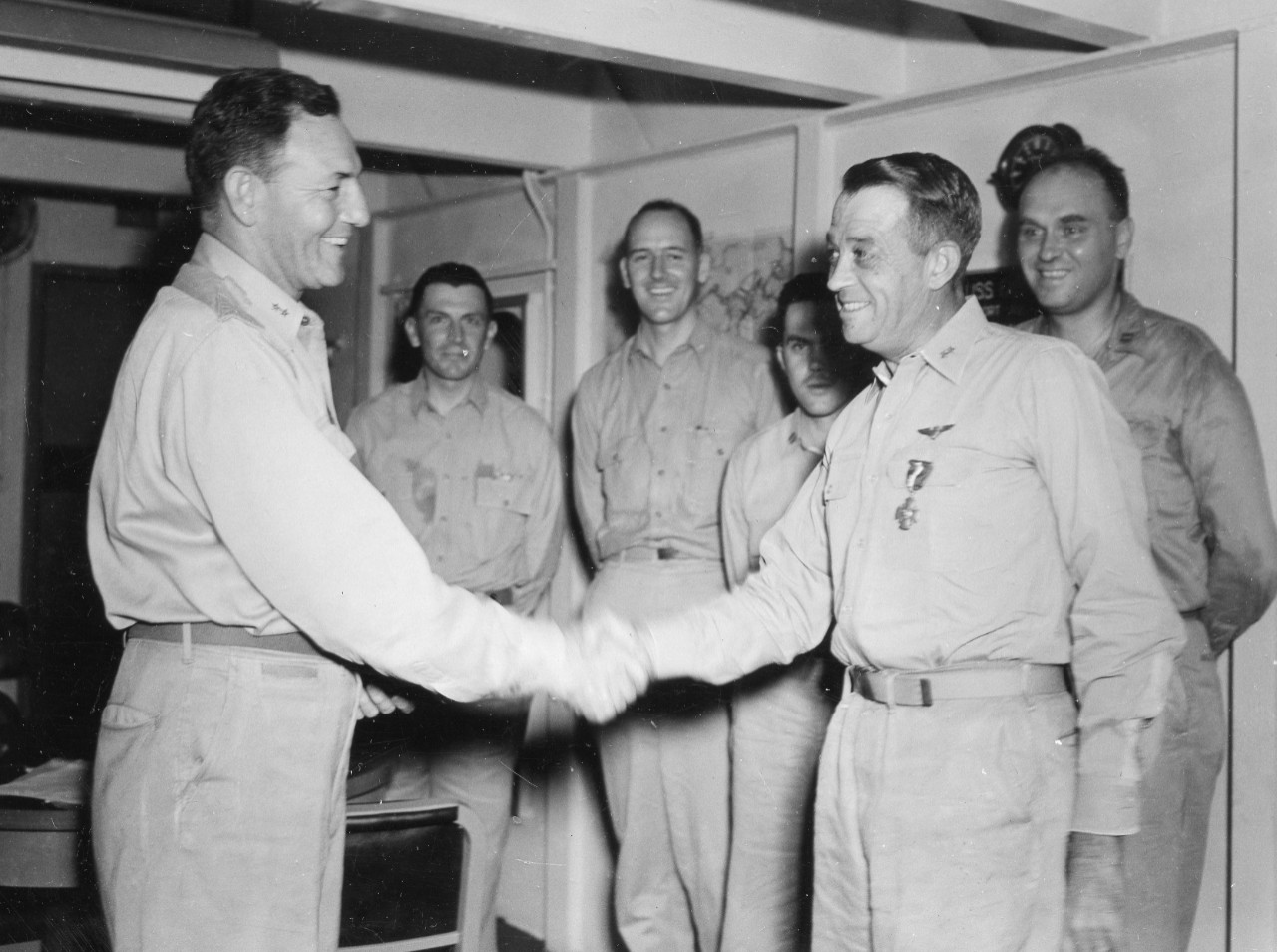 On board Fanshaw Bay, 15 March 1945, Rear Adm. Calvin T. Durgin awards Rear Adm. Clifton Sprague the Navy Cross, honoring the latter’s heroic leadership of Taffy 3 off Samar on 25 October 1944. (U.S. Navy Photograph 80-G-364246, National Archives...