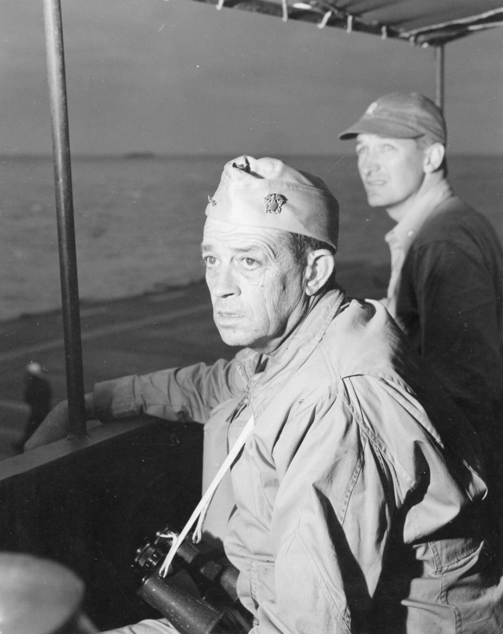 The tension of the Okinawa campaign clearly shows on the faces of Rear Adm. Sprague and Lt. Cmdr. Anderson F. Hewitt as they watch flight operations from the bridge, April 1945. (U.S. Navy Photograph 80-G-371327, National Archives and Records Adm...
