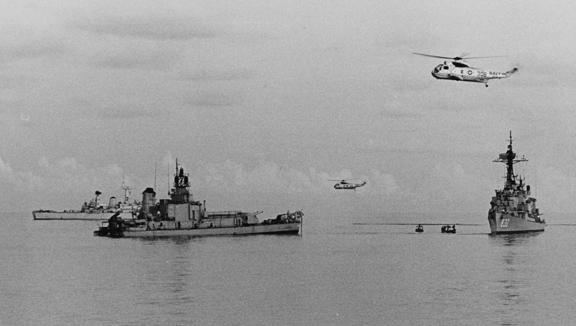 SH-3A Sea Kings flying from Kearsarge join the search and rescue operations over the stern section of Frank E. Evans, as Everett F. Larson (right) and British frigate Cleopatra (back left) render assistance, 2 June 1969. (U.S. Navy Photograph NH ...