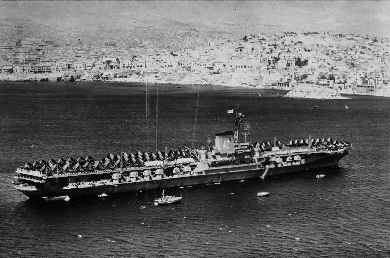Franklin D. Roosevelt anchors in the bay off Piraeus in her important task of emphasizing U.S. resolve for the Greek government against the communists, 5–9 September 1947. (Naval History and Heritage Command Photograph 2014.10.01)