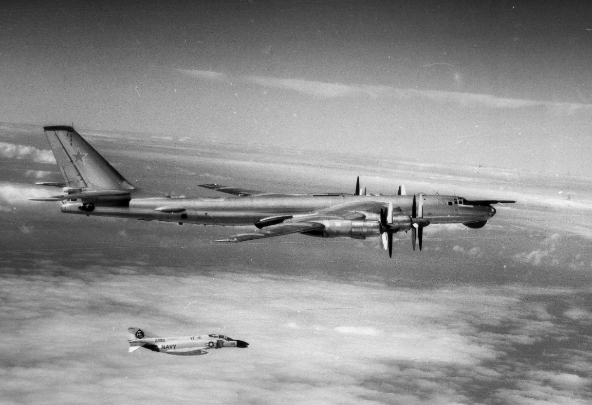 Aircraft No. 102, an F-4J Phantom II (BuNo 152293) of VF-41, flying from Franklin D. Roosevelt intercepts an intrusive Soviet Tupolev Tu-95 Bear-D as it investigates the ship while she deploys to the Mediterranean, 22 September 1973. (Naval Histo...