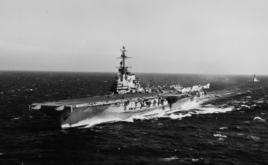 A mix of aircraft are parked on Franklin D. Roosevelt’s flight deck as she steams at sea, a plane guard escort faithfully following in her wake, 3 March 1963. (Naval History and Heritage Command Photograph 1074673)