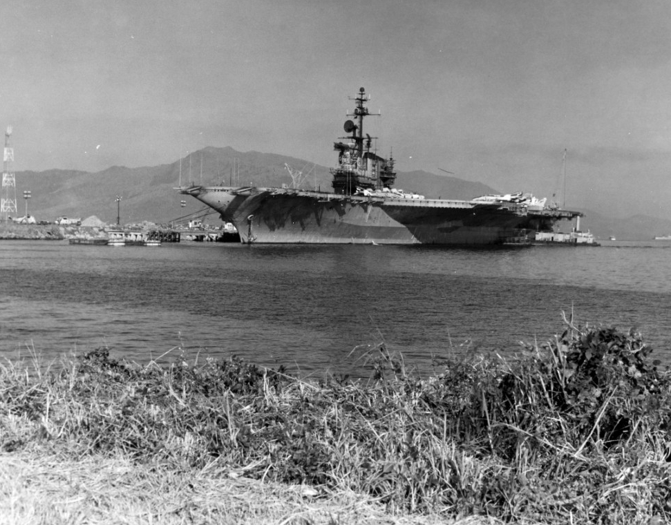 Some of the Phantom IIs that flew off Franklin D. Roosevelt’s flight deck into the inferno of North Vietnamese air defenses are visible in this port bow view of the ship as tugs ease her to the pier and sailors secure mooring lines at NAS Cubi Po...