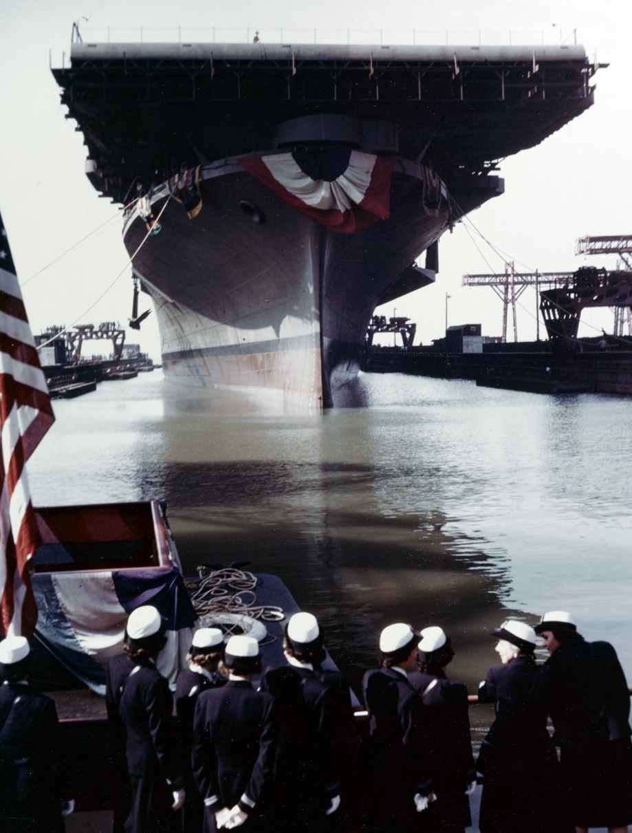 Franklin is floated out of her building dock following her christening at the Newport News Shipbuilding & Dry Dock Company shipyard, Newport News, on 14 October 1943. Note the WAVES officers in the foreground. (U.S. Navy Photograph 80-G-K-14015, ...