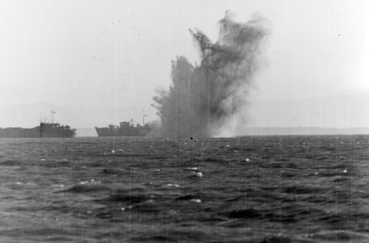 A Luftwaffe aircraft’s bomb explodes amongst the invasion shipping off Anzio, on 22 January 1944. The vessel in the background is possibly HMS Princess Beatrix. Photographed from on board Frederick C. Davis (U.S. Navy Photograph 80-G-223444, Nati...