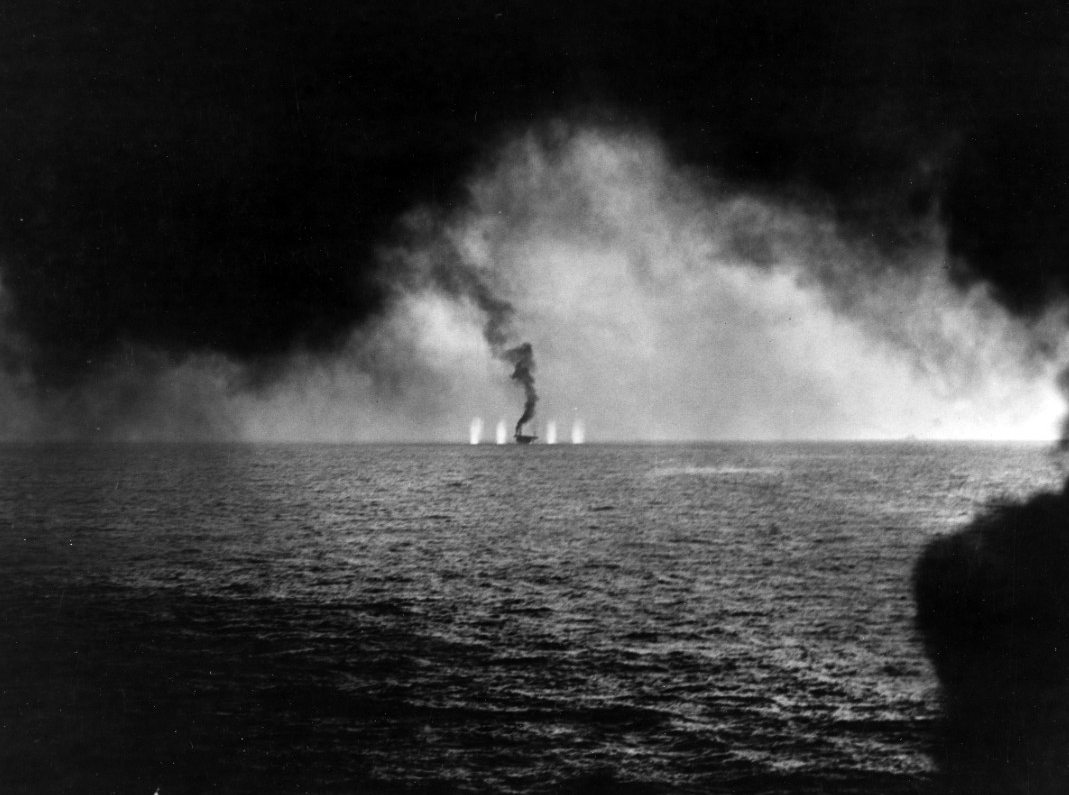 Huge geysers of water erupt around Gambier Bay as a Japanese cruiser, most likely Chikuma (barely discernable on the horizon on the right), fires at her, 25 October 1944. (U.S. Navy Photograph 80-G-287505, National Archives and Records Administra...