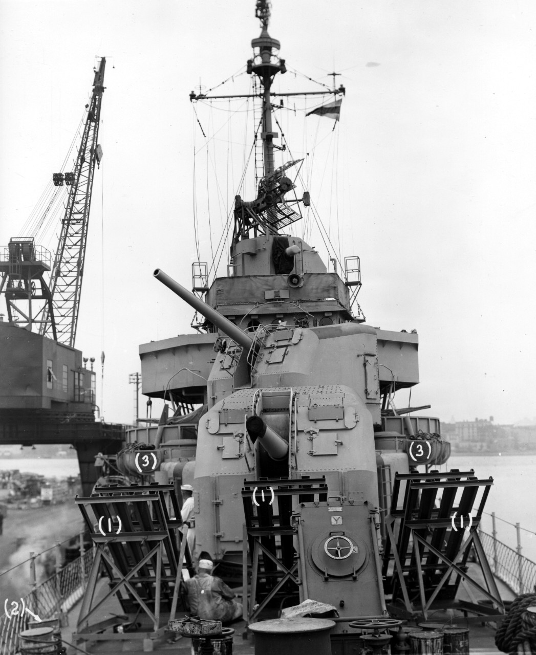 Looking aft from Glennon’s forecastle during a period of repairs and alterations at the New York Navy Yard, 3 September 1943. Note three prominent “mousetrap” anti-submarine rocket launchers, so named because of the obvious similarity with the ro...