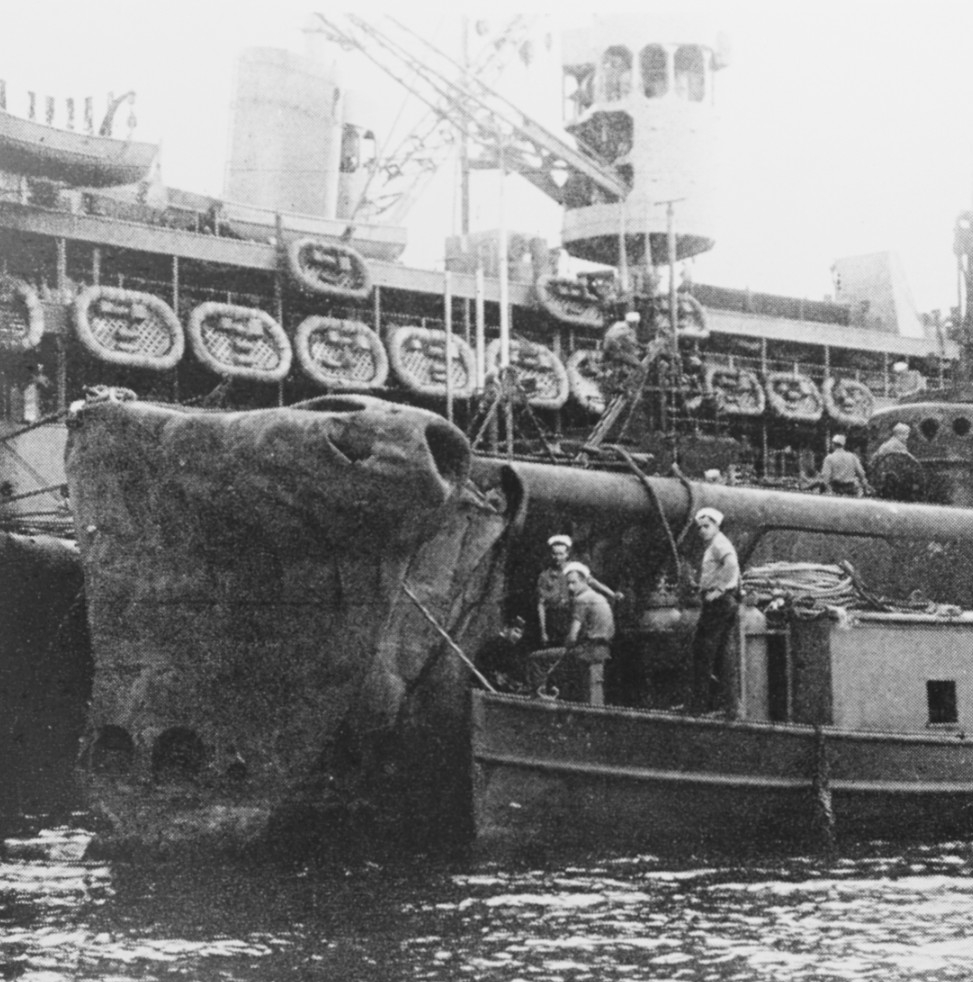 Growler alongside Fulton (AS-11) at Brisbane, Australia, in February 1943, after ramming Hayasaki in the Bismarck Islands. Note her badly bent bow. (Naval History and Heritage Command Photograph NH 74515)