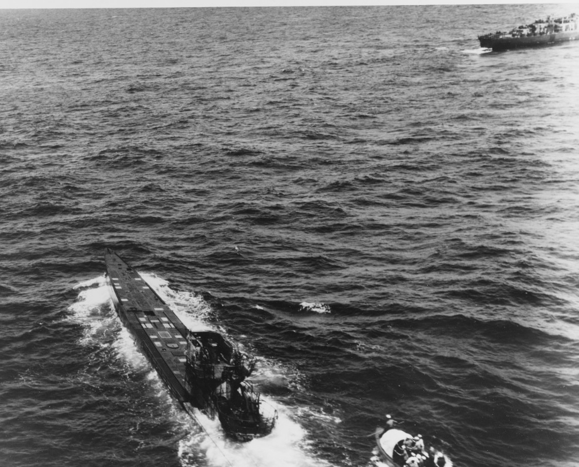 Lt. (j.g.) David leads his boat crew (lower right) toward U-505, which continues to steam though abandoned by her crew, 4 June 1944. Chief Jacobson stands ready with a boarding gaff in the boat’s bow. (U.S. Navy Photograph 80-G-49166, National Ar...
