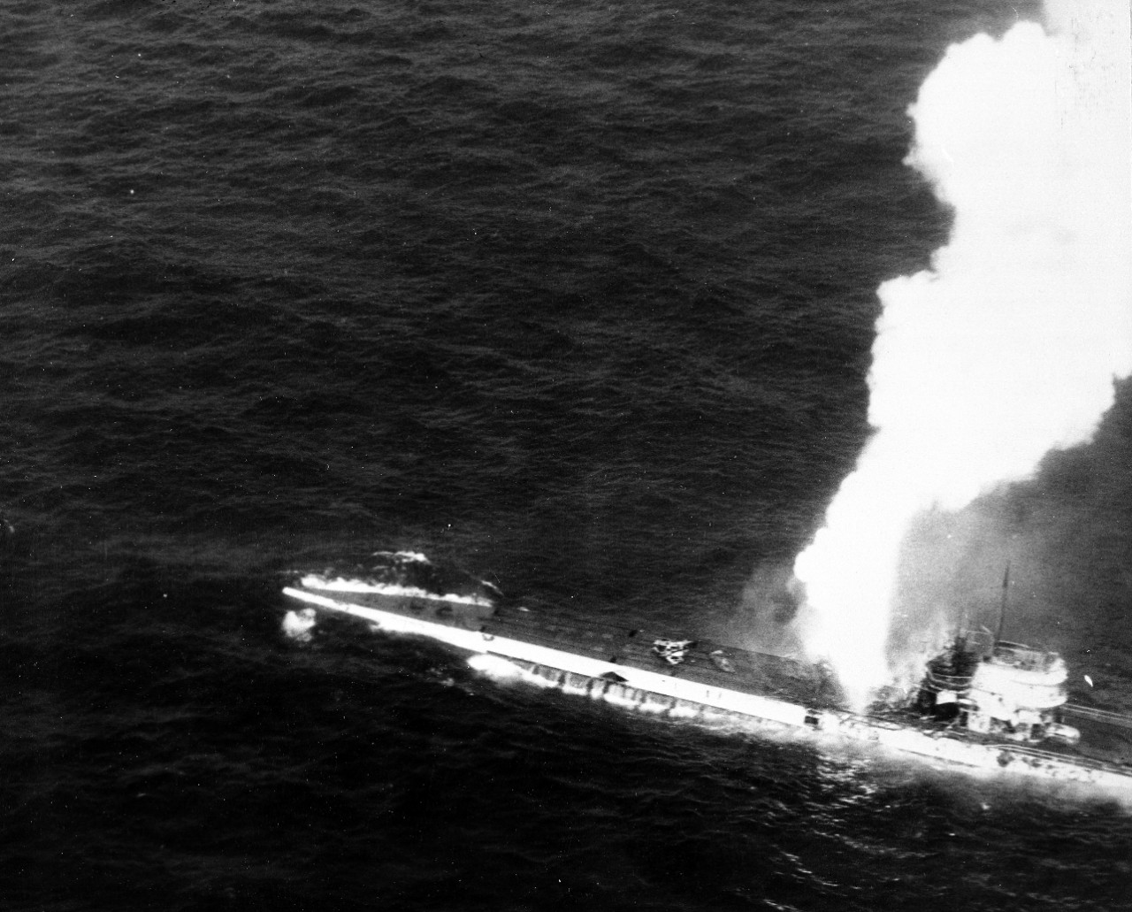 A plane flying from Guadalcanal snaps a picture of U-515 as the submarine burns and sinks, 9 April 1944. The explosion appears to be erupting from the boat’s aft antiaircraft gun battery. (U.S. Navy Photograph 80-G-227197, National Archives and R...