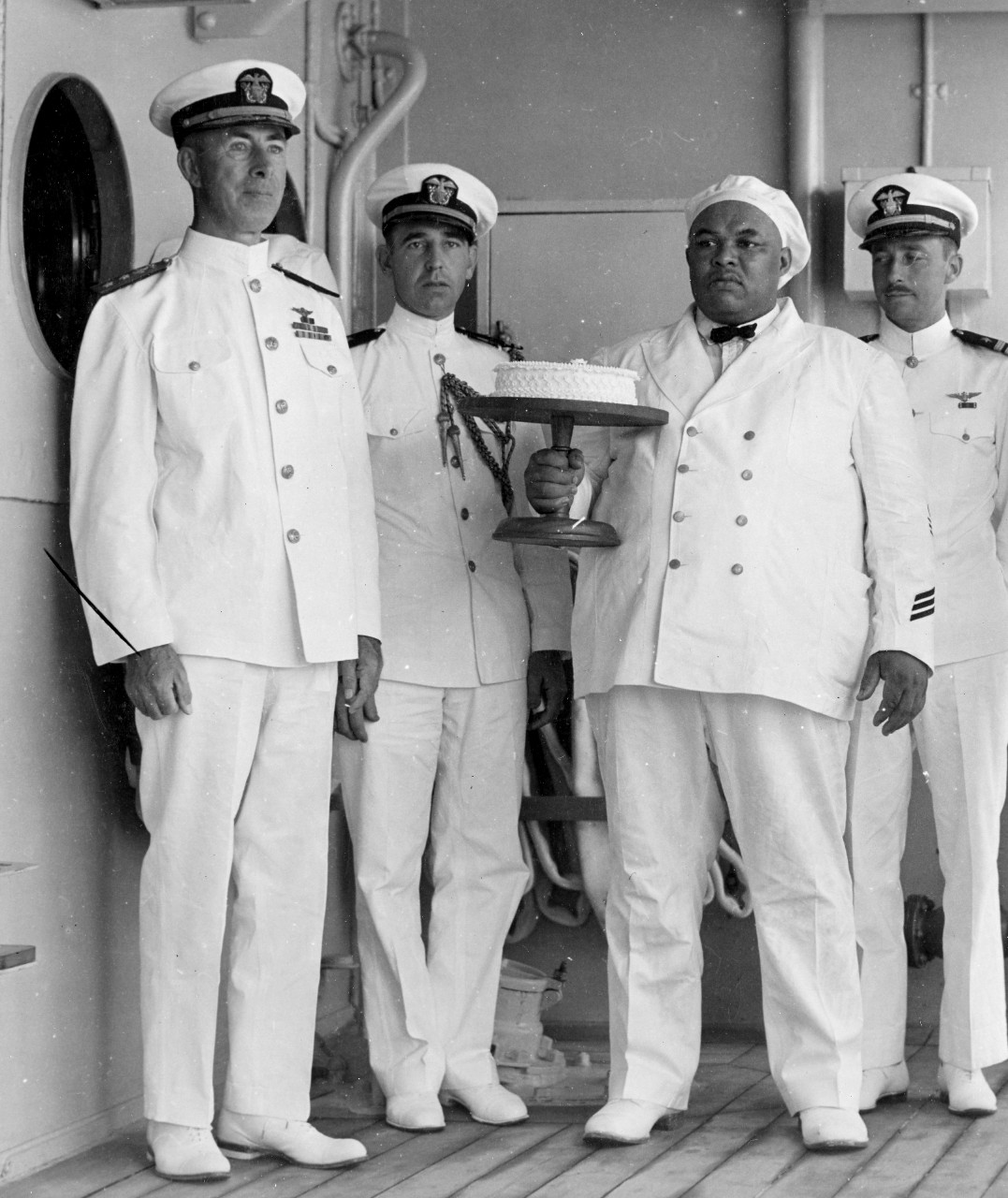 Rear Adm. Halligan and Lt. Ward receive cake, 18 May 1934. (U.S. Navy Photograph 80-G-462748, National Archives and Records Administration, Still Pictures Division, College Park, Md.)