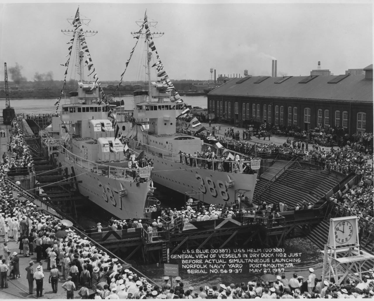 Blue (DD-387) (L) and Helm await christening in the partially flooded Dry Dock No. 2 at the Norfolk Navy Yard, 27 May 1937. Blue appears to have her guns and torpedo tubes installed, and both ships’ Mk. 33 main battery gun directors are in place....