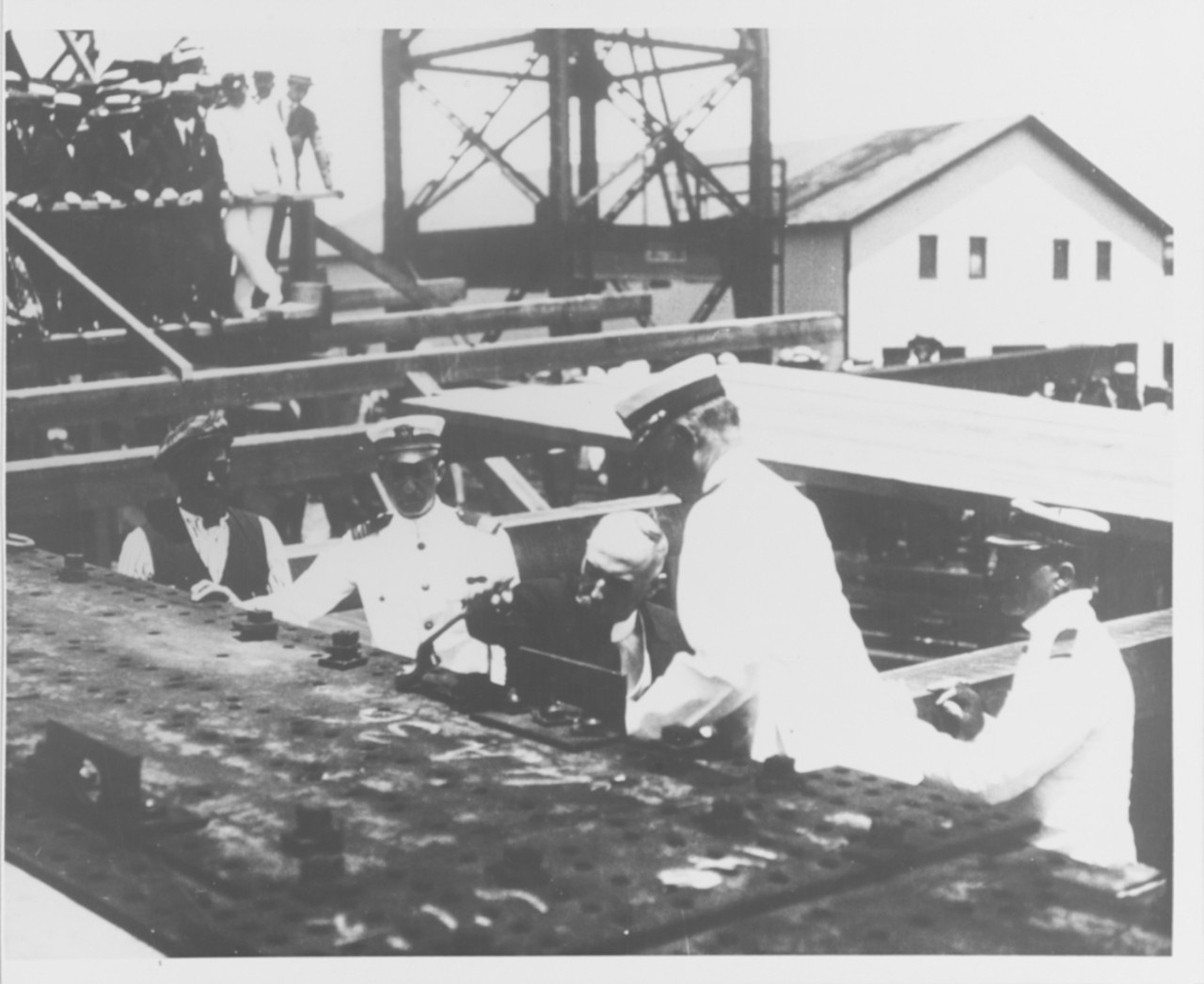 Adm. William S. Benson, Chief of Naval Operations, places the first bolt in Henderson's keel on 19 June 1915, at the Philadelphia Navy Yard. (Naval History and Heritage Command Photograph NH 53502)