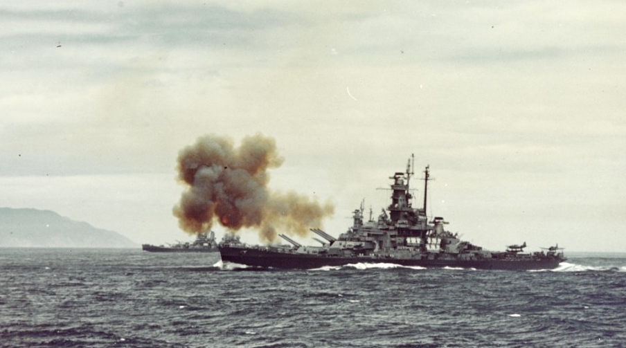 Indiana fires a salvo from her forward 16-inch guns at the plant at Kamaishi, 14 July 1945. A second before, South Dakota, from which this photograph is taken, fired the initial salvo of the first naval gunfire bombardment of the Japanese Home Is...