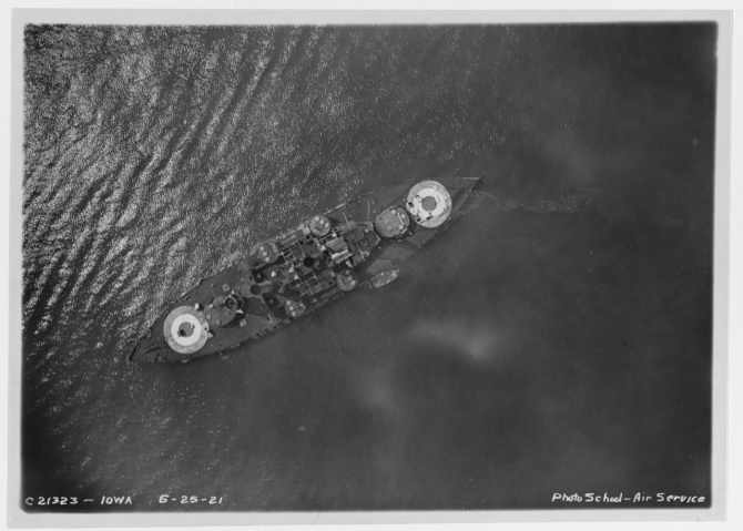 An Army Air Service plane photographs Coast Battleship No. 4 from above during the bombing tests off the Virginia capes, 25 June 1921. Note the large targets painted fore and aft. (Naval History & Heritage Command Photograph NH 93549)