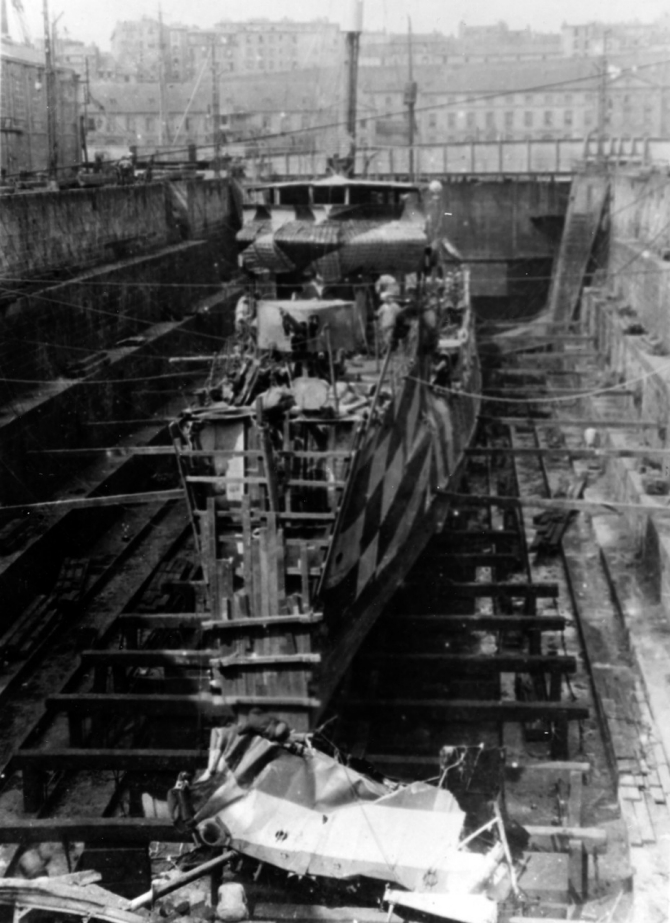 Jarvis on 22 July 1918 at Brest, France in drydock after her collision with Benham (Destroyer No. 49). The wreckage of her bow was cut away by a repair crew from Prometheus (Repair Ship No. 2). Upon completion of temporary repairs, Jarvis went to Birkenhead, England, where permanent repairs were completed in September 1918. (Naval History and Heritage Command Photograph NH 64983)