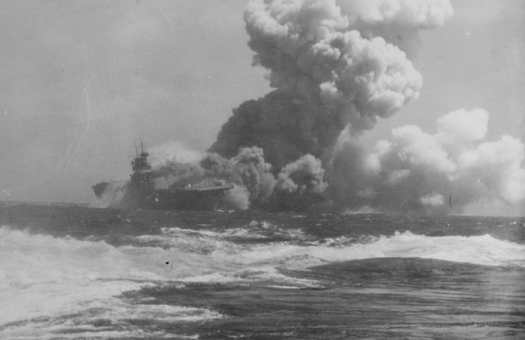 Wasp, afire and sinking, as seen from San Francisco (CA-38), south of San Cristobal Island, after being torpedoed by I-19, 15 September 1942. (U.S. Navy Photograph 80-G-391481, National Archives and Records Administration, Still Pictures Division...