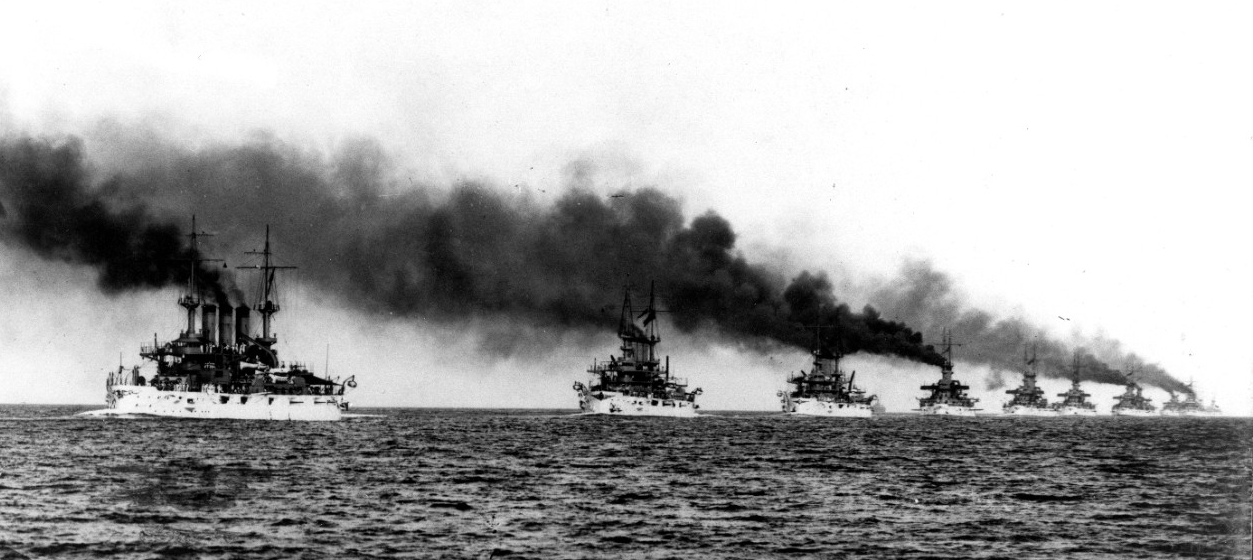 The Great White Fleet steams in column from Hampton Roads, Va. at the beginning of their cruise around the world, 16 December 1907. Kansas (Battleship No. 21) (left) and Vermont (Battleship No. 20) (next in line) lead the ships in this C.E. Water...