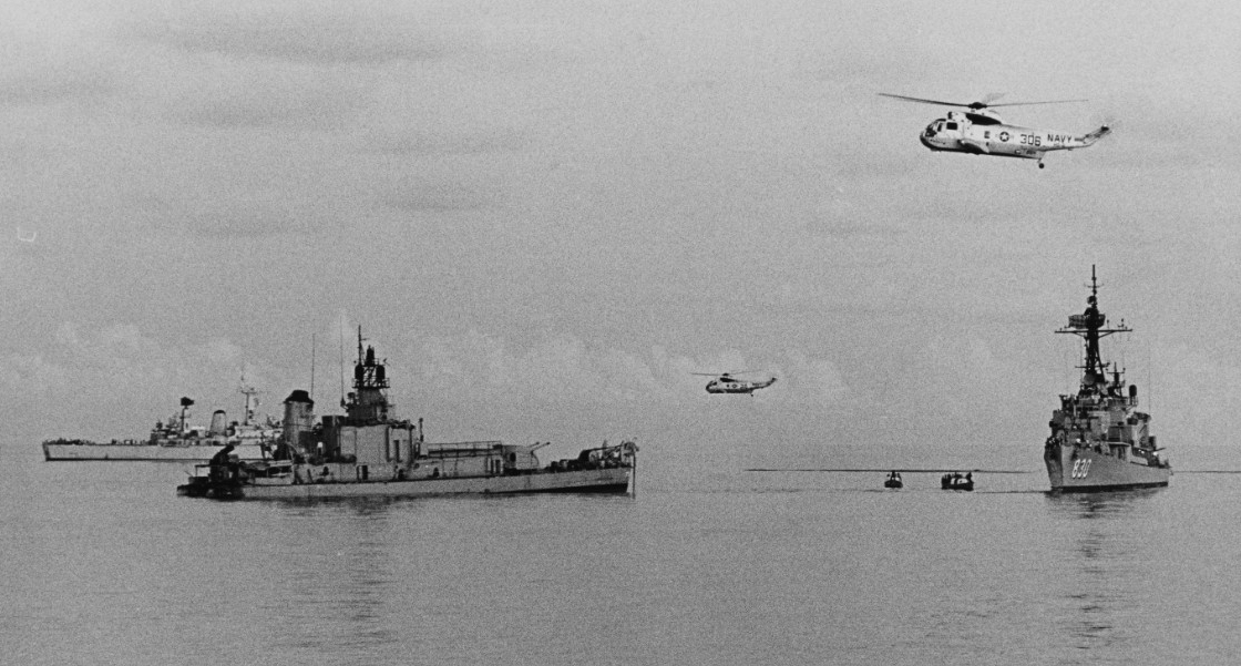SH-3A Sea Kings flying from Kearsarge join the search and rescue operations over the stern section of Frank E. Evans, as Everett F. Larson (right) and British frigate Cleopatra (F-28) (back left) render assistance, 2 June 1969. (U.S. Navy Photogr...
