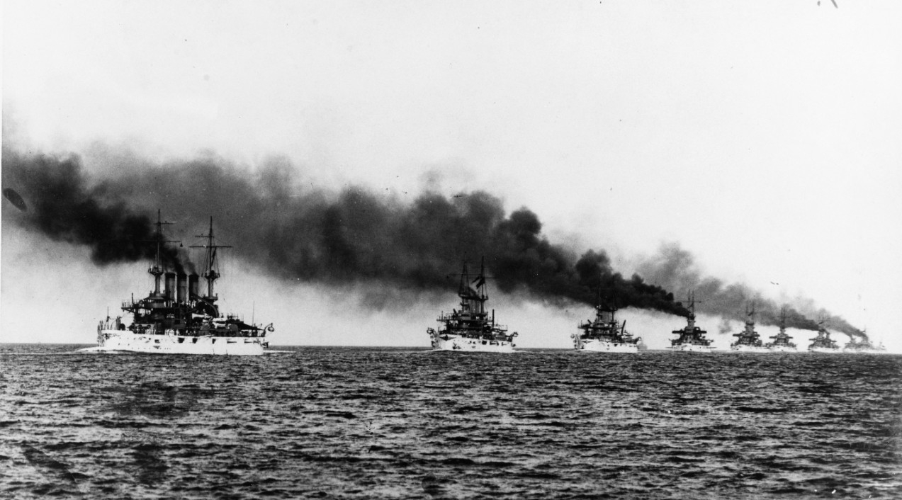 The Great White Fleet steams in column from Hampton Roads, Va. at the beginning of their cruise around the world, 16 December 1907. Kansas (Battleship No. 21) (left) and Vermont (Battleship No. 20) (next in line) lead the ships in this C.E. Water...