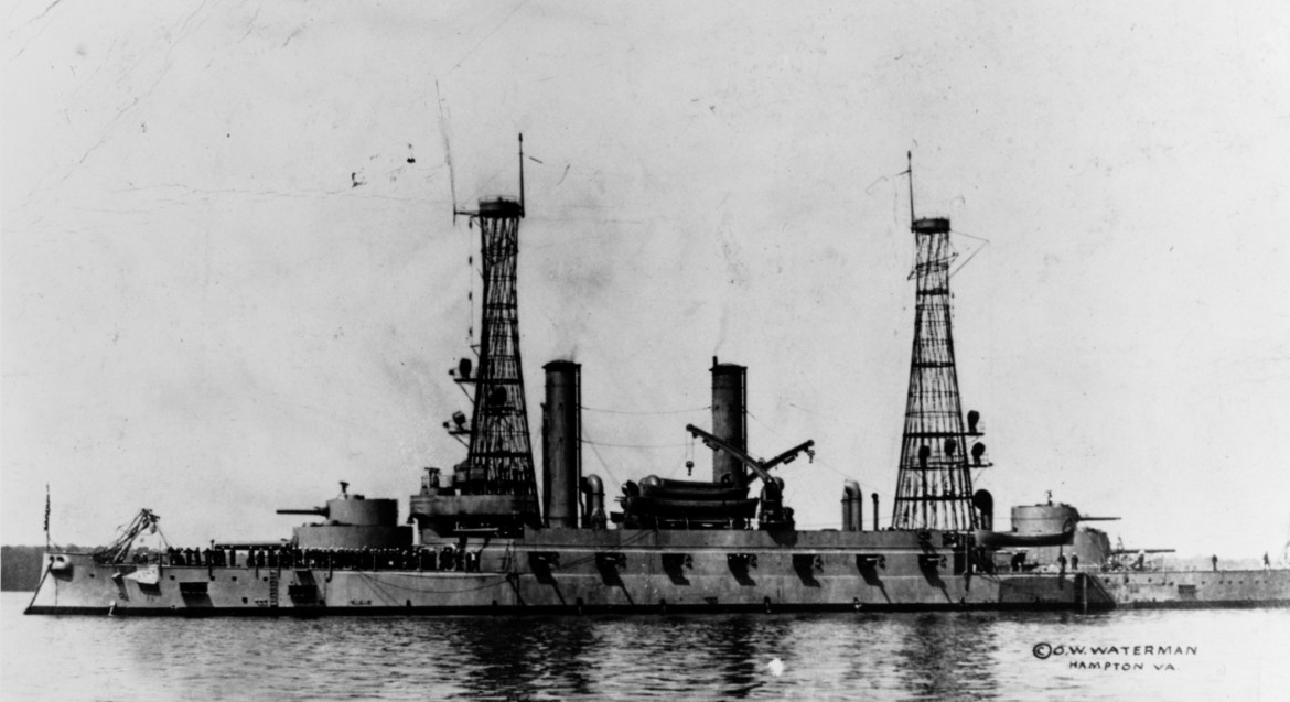A wartime view of Kentucky at Hampton Roads, circa 1918. Note the distinctive cage masts, and that most of her original 5-inch guns have been removed, leaving only four per side. (Naval History and Heritage Command Photograph NH 80744)