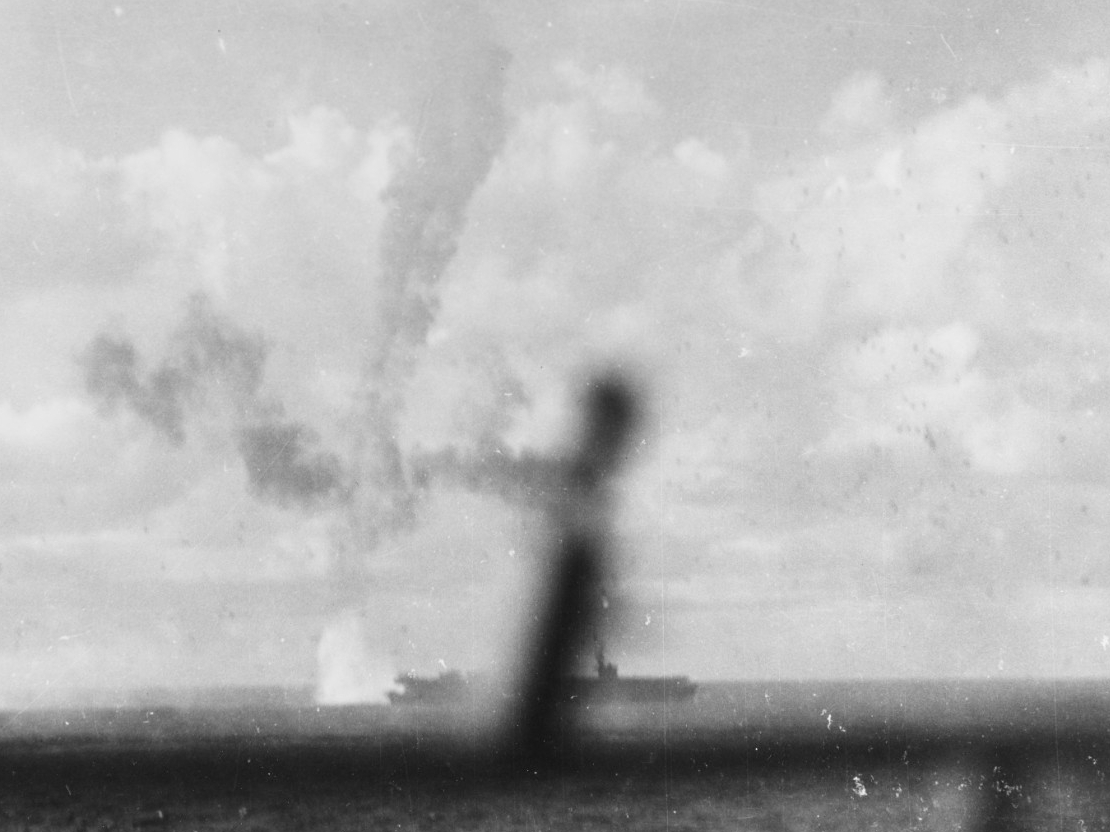 A fiery trail marks a Japanese plane’s final plunge into the sea just astern of Kitkun Bay, 18 June 1944. (U.S. Navy Photograph 80-G-243432, National Archives and Records Administration, Still Pictures Division, College Park, Md.)
