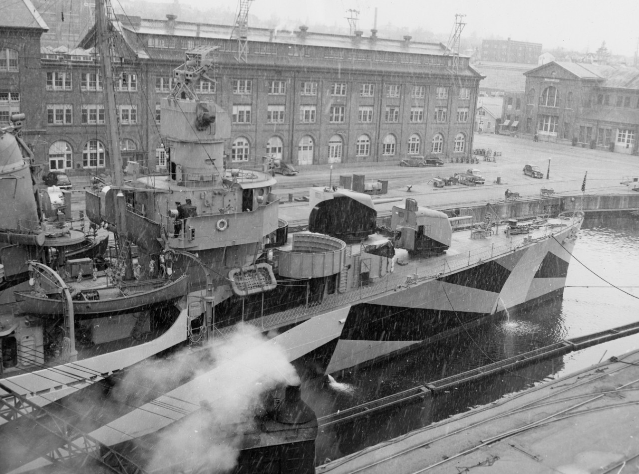 As snow falls, Leutze fits out in dry dock at Bremerton, 12 March 1944. Note her Measure 31, Design 16D camouflage and that her forward 40-millimeter guns have not yet been fitted, but her radar is in place atop her Mk. 37 director. (U.S. Navy Bu...