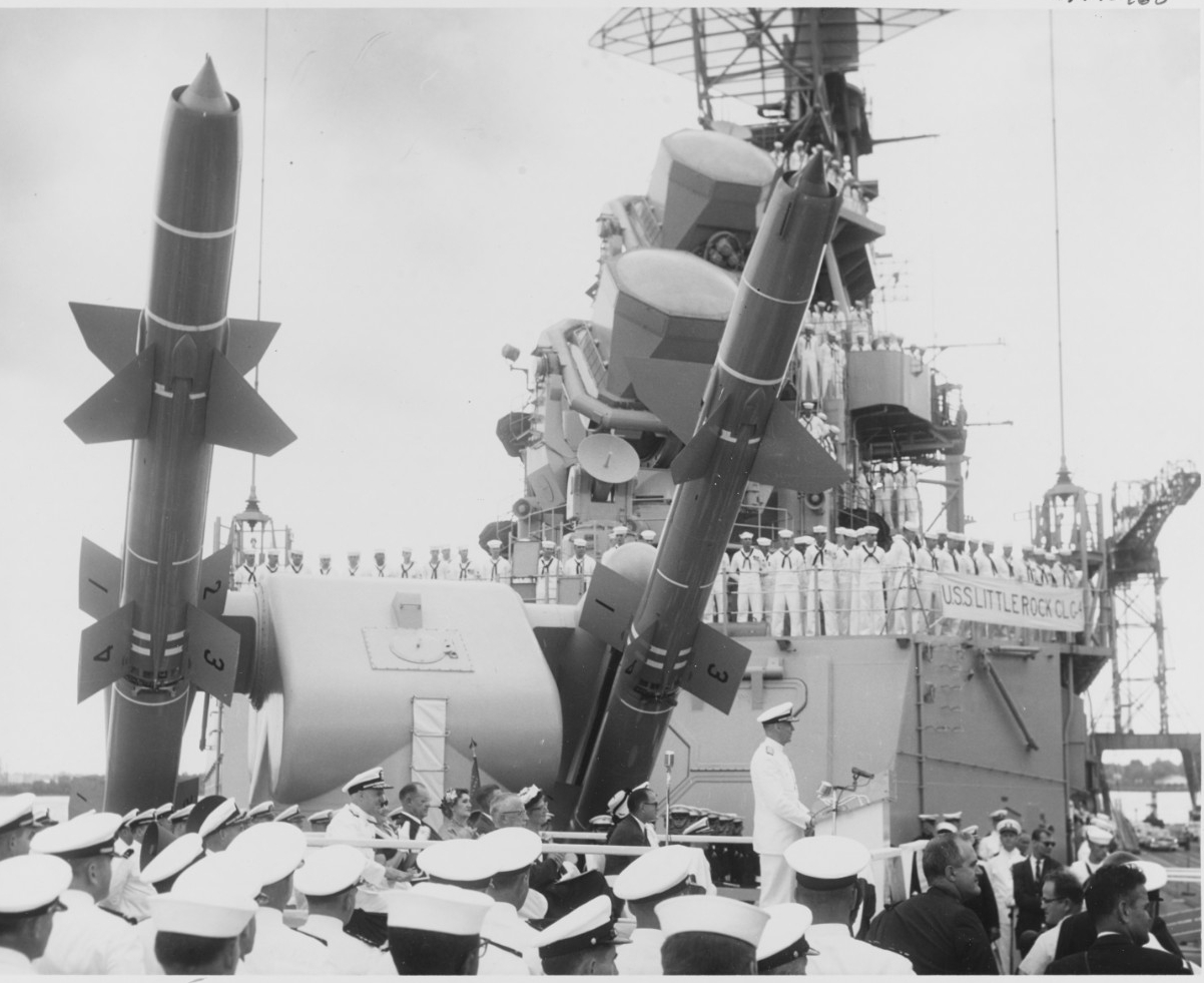 Rear Adm. Charles H. Lyman speaking during the ship's commissioning ceremonies, at the Philadelphia Naval Shipyard, 3 June 1960. Note Talos guided missiles behind the speaker's platform. (Naval History and Heritage Command Photograph NH 98963)