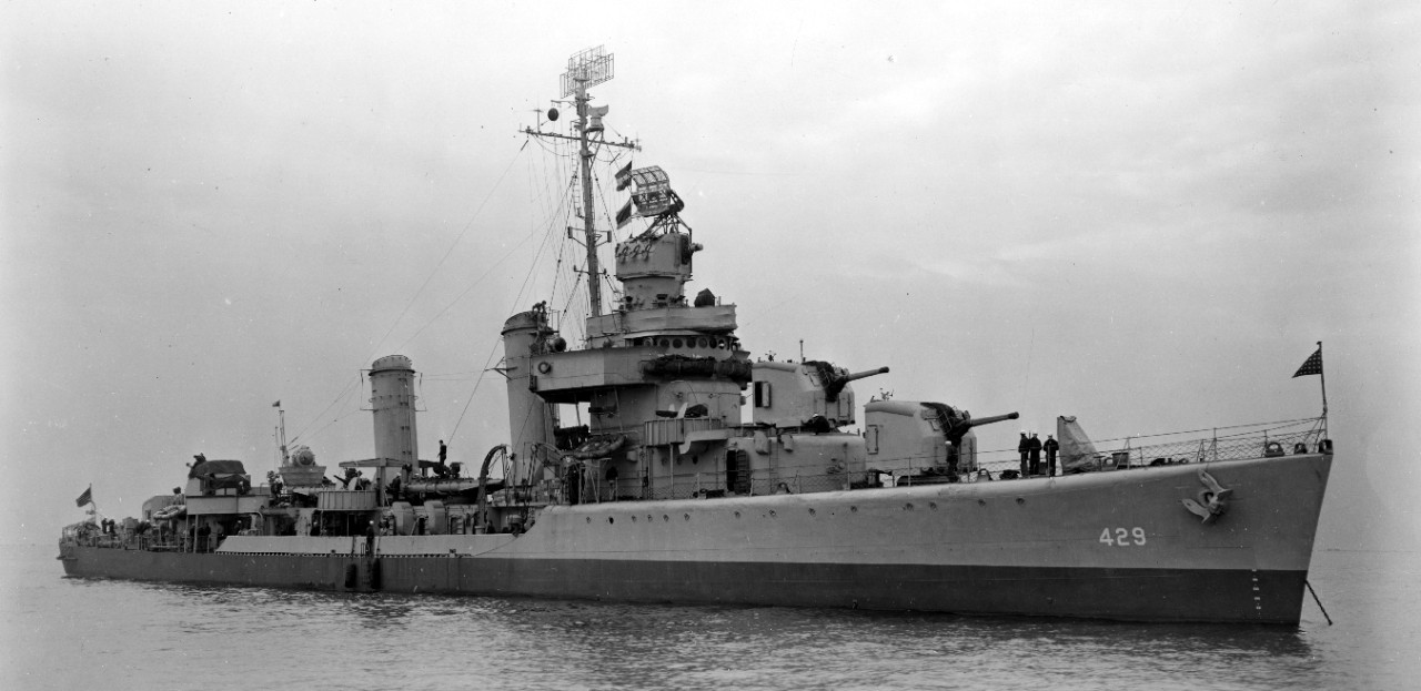 Livermore anchored at New York, 24 September 1943, showing her two-tone graded camouflage, the dividing line between upper and lower colors following the horizon instead of the sheer of the main deck. Close examination of the original print shows...