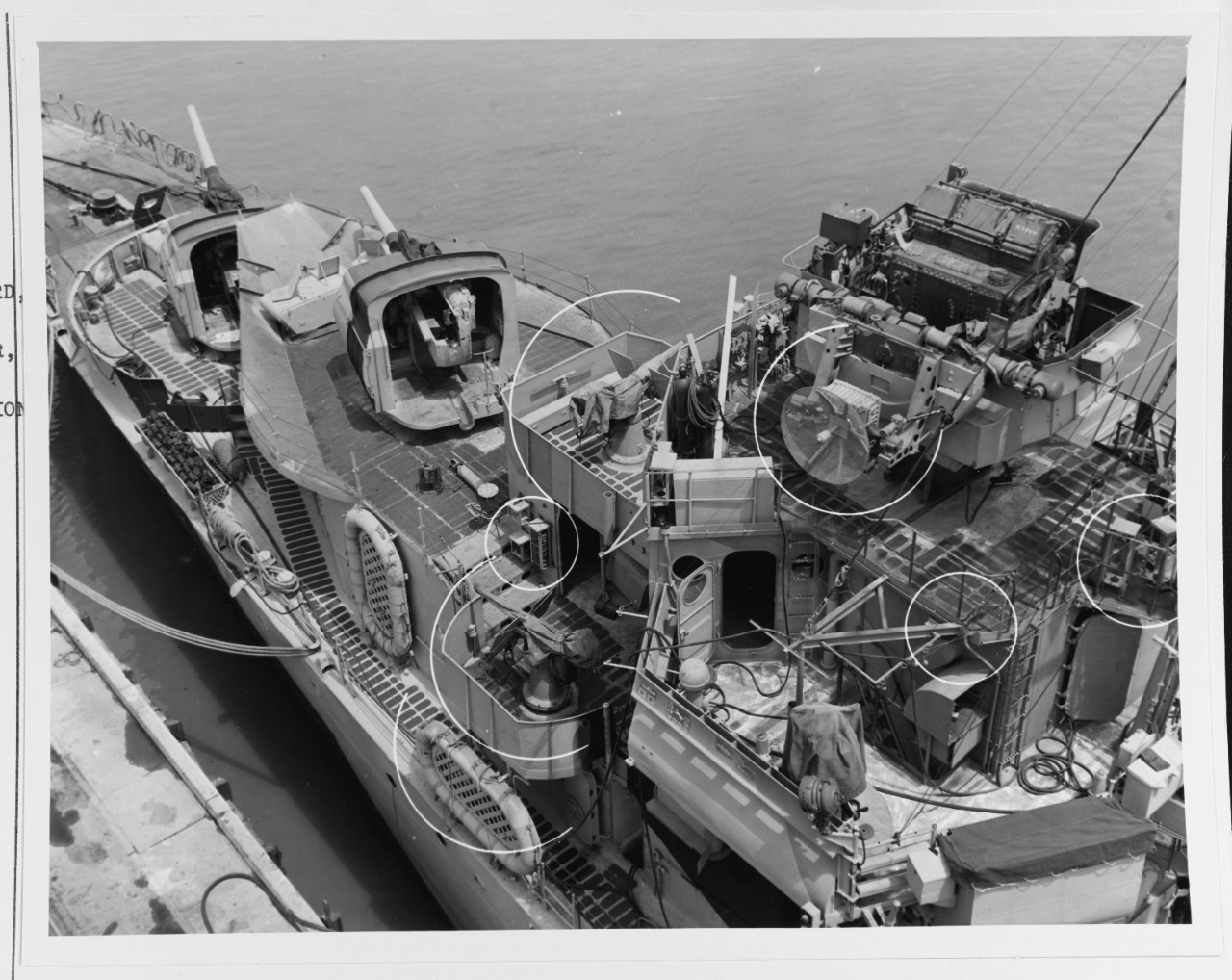 Close-up view of Mahan’s forward superstructure, taken at Mare Island on 24 June 1944. View looks down on the port side of the pilothouse, and shows the destroyer’s Mk. 33 gun director, with fire control radar antenna, in the upper right. Also se...