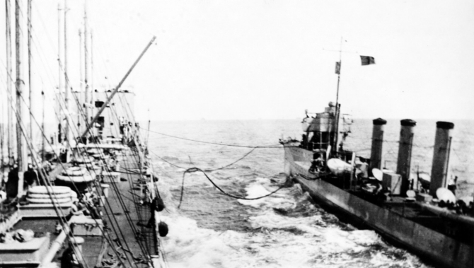 Maumee replenishes McCall’s fuel bunkers, 22 September 1917. Note red "Baker" refueling flag flying from the destroyer. (Naval History and Heritage Command Photograph NH 93098).