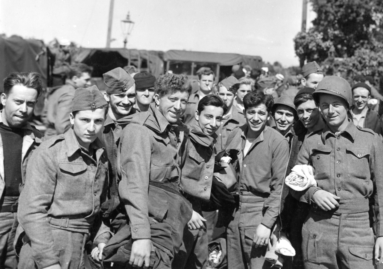 A close up photograph of some of the survivors, the men’s faces running the gamut of emotions from exhaustion to shock to elation at being alive, circa 10 June 1944. (U.S. Navy Photograph 80-G-243667, National Archives and Records Administration,...