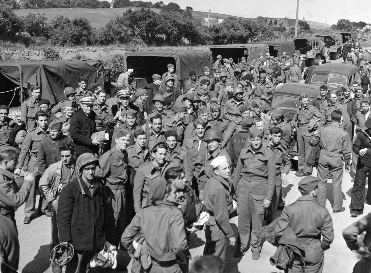 Some of Meredith’s survivors gather gratefully for the camera following their rescue at Vicarage Field near London, England, circa 10 June 1944. Some of the men wear British uniforms given to them by their allies to replace the kits they lost whe...
