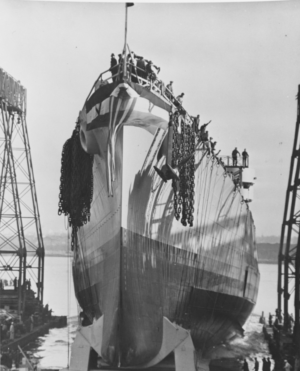 Launching of Miami at Philadelphia, Pa., on 8 December 1942. Note the anchors and chains at the ship’s bow, positioned in preparation for stopping her once she moves out into the water. (Naval History and Heritage Command Photograph NH 75601)
