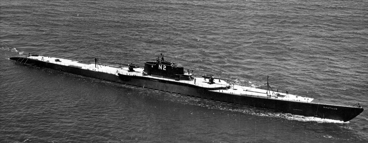 Nautilus underway at sea, 16 June 1937, painted black with her wooden decks unpainted, with her identification number N-2 and the “E” award on the after end of her conning tower white. Note the small platform at the forward end of the fairwater, ...