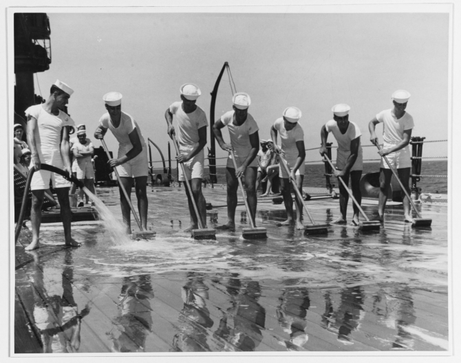 The seven Patten brothers man the brooms for clean-up detail, circa September 1941. From left to right: Bruce, Ray, Allen, Myrne, Clarence, Jr., Marvin, and Gilbert. (Naval History and Heritage Command Photograph NH 51886)