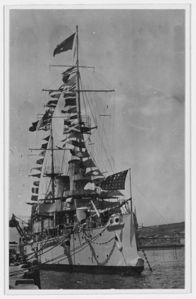 Olympia gaily dresses with flags and celebrates Bastille Day while at Fiume on the Adriatic Sea, 14 July 1919. (R.E. Wayne J-61, U.S. Navy Photograph NH 43260, Photographic Section, Naval History and Heritage Command)