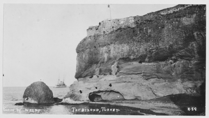 Olympia rounds the headland at Trebizond [Trabzon], Turkey, the ancient Byzantine and Turkish fortress visible atop the cliff, August 1919. (R.E. Wayne K-89, U.S. Navy Photograph NH 122302, Photographic Section, Naval History and Heritage Command)