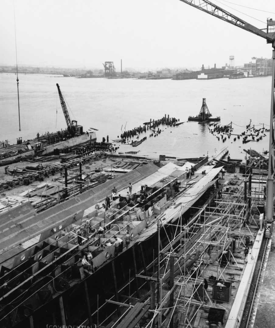 Tallahassee under construction at New York Shipbuilding Corp., Camden, N.J., 1 July 1941. This view looking aft from about amidships shows the keel, double bottom structure, and bottom planking. (U.S. Navy Bureau of Ships Photograph 19-N-44097, N...
