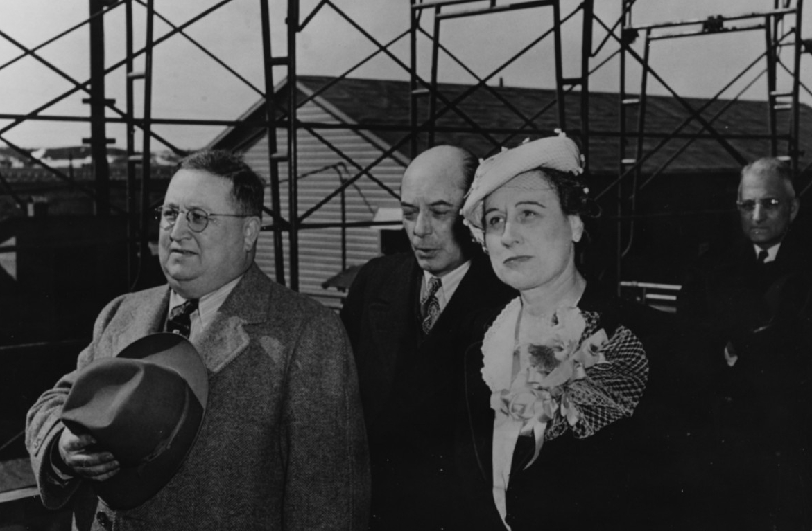The ship’s sponsor party stands at attention as FP-344 slides down the ways at Kewaunee, Wisc., 16 April 1944. Dorothy K. Duvall, the sponsor, is in the right foreground, and also present are Hugh C. Brogan, Vice President and General Manager of ...