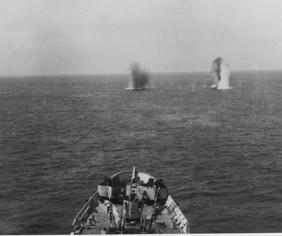 German shells splash off Quincy’s bow, as seen from her bridge, 25 June 1944. (Naval History and Heritage Command Photograph NH 82515)