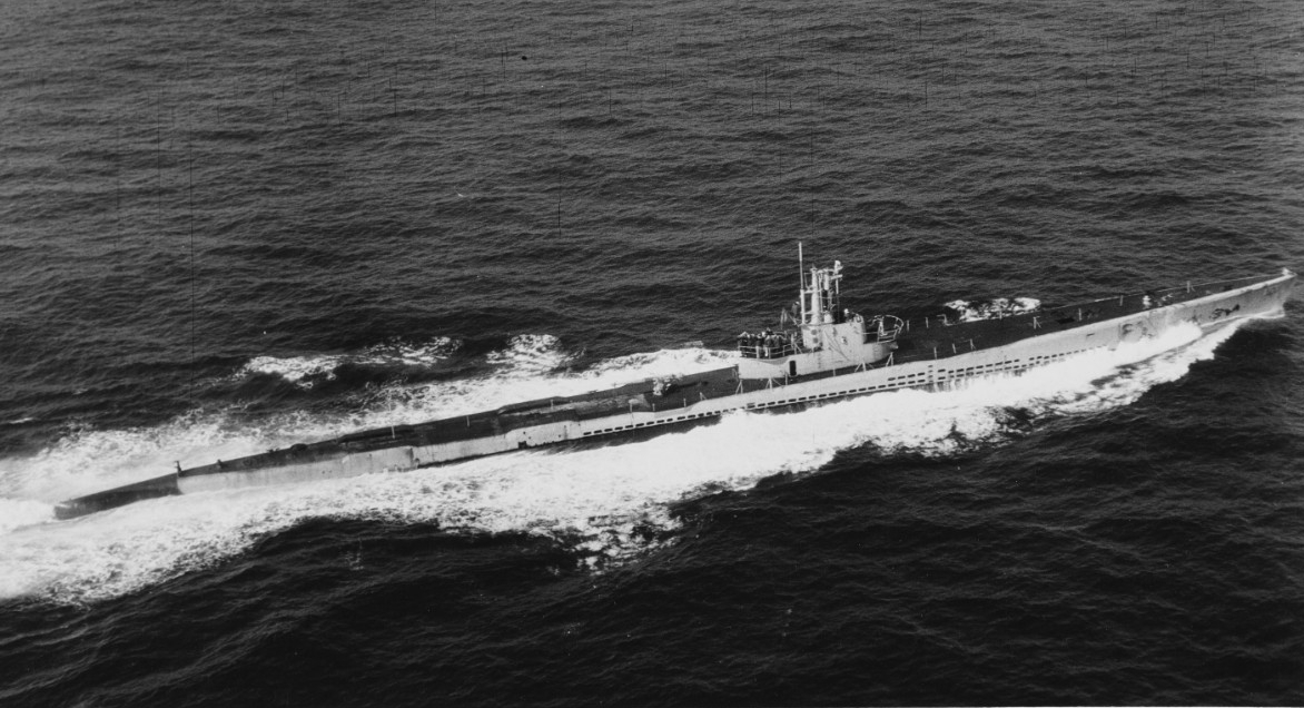 A blimp of Airship Patrol Squadron (ZP) 24 photographs Salmon as she concludes her war and steams through the deceptively calm Atlantic for Portsmouth Navy Yard, N.H., 15 February 1945. (Naval History and Heritage Command Photograph NH 97464)