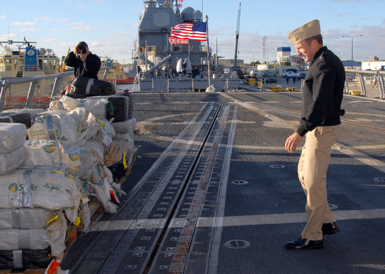 Rear Adm. Joseph D. Kernan, Commander Naval Forces Southern Command and Fourth Fleet, inspects some of the seized cocaine stacked on Samuel B. Roberts’ fantail after the ship returns to Mayport, Fla., 12 December 2008. (MC1 Leigh Stilles, U.S. Na...
