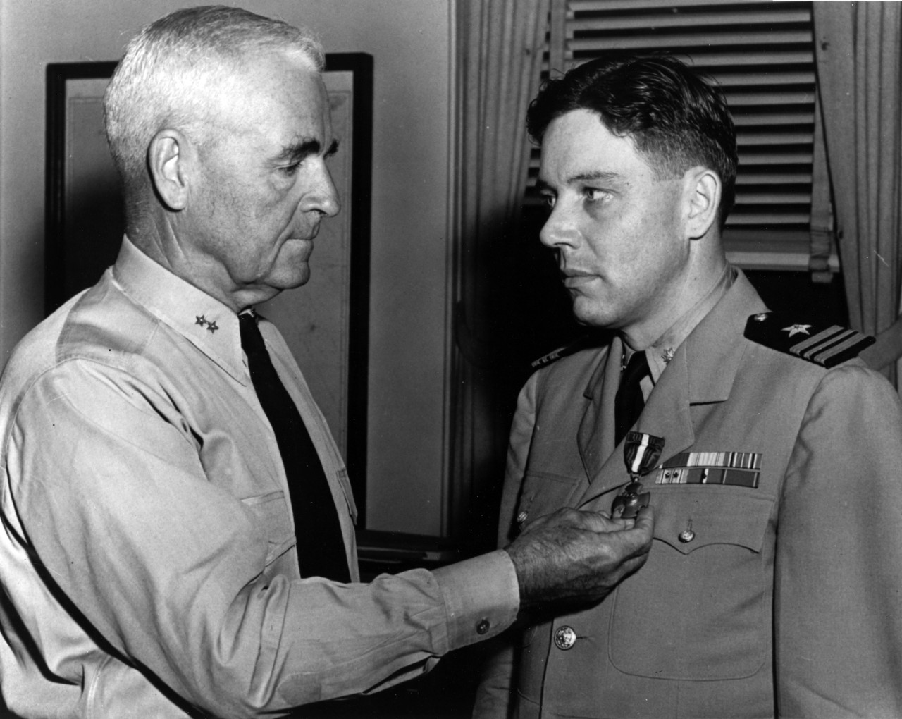 Rear Adm. David M. LeBreton awards Lt. Cmdr. Copeland the Navy Cross for heroism while in command of Samuel B. Roberts in the Battle off Samar, on 25 October 1944. This ceremony took place at Norfolk, Va., on 16 July 1945. (Naval History and Heri...