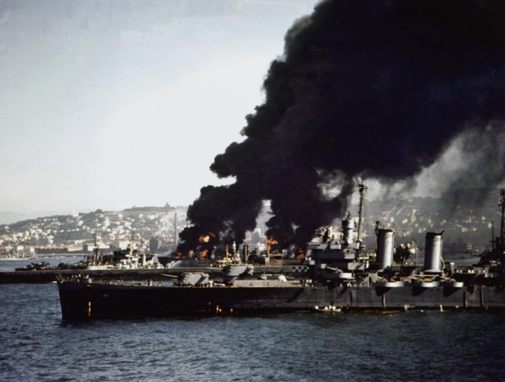Savannah stands by to render assistance as vessels burn after Norwegian cargo ship Bjørkhaug explodes in Algiers harbor, 16 July 1943. (U.S. Navy Photograph 80-G-K-3965, National Archives and Records Administration, Still Pictures Division, Colle...