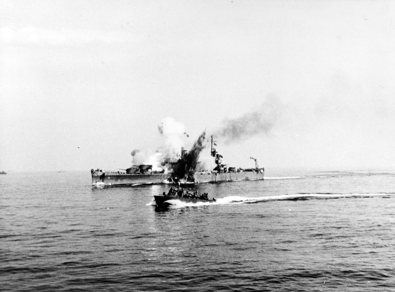 The Fritz-X tears into Savannah’s Turret III while she steams off Salerno, at 0944 on 11 September 1943. The bomb penetrates through the turret and deep into her hull and explodes, the blast venting through the top of the turret and also through ...
