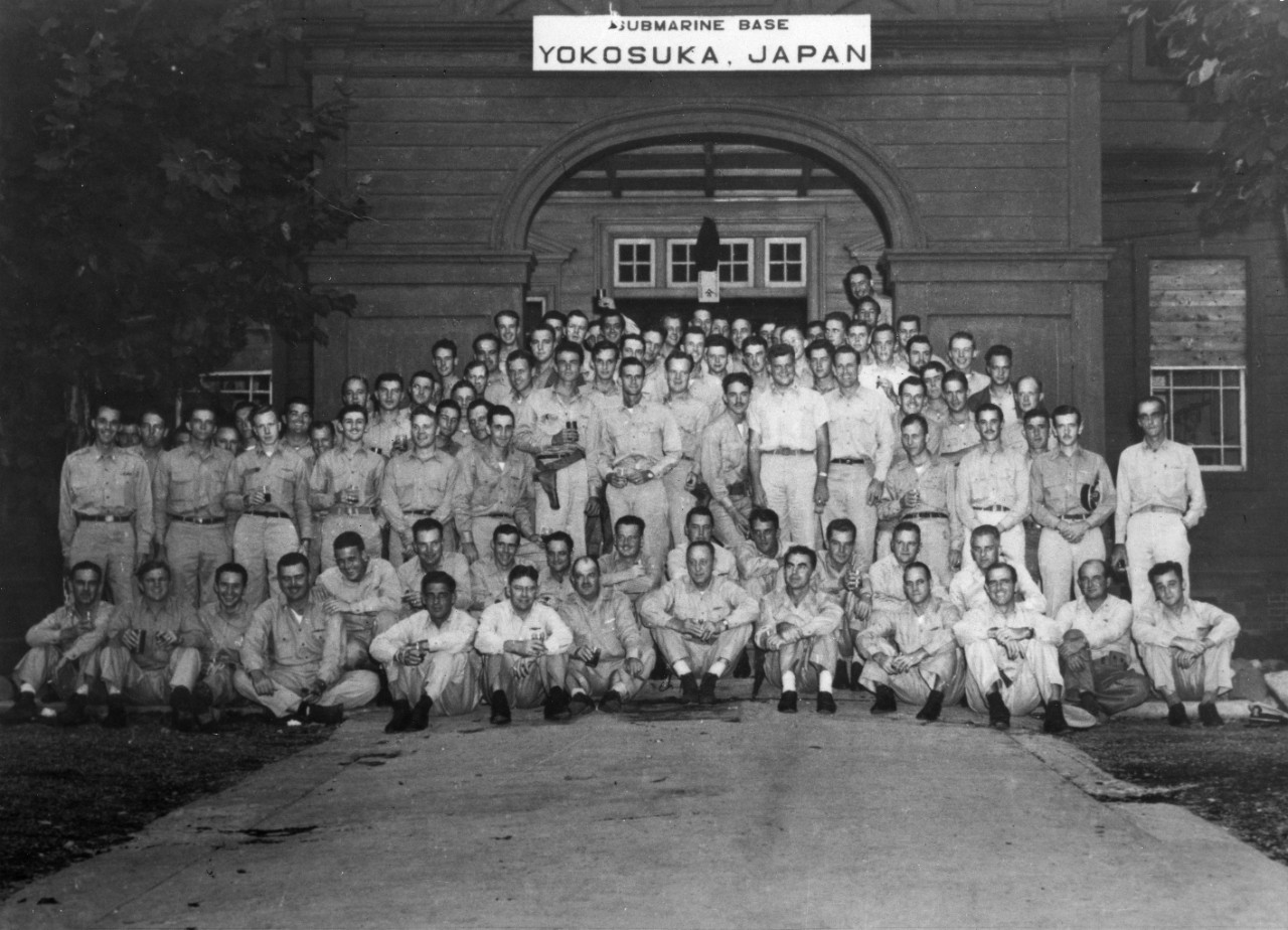 Vice Adm. Charles A. Lockwood, Commander Submarine Force, Pacific Fleet (seated, center), poses with some of his officers at the newly established Yokosuka Submarine Base, 2 September 1945, while celebrating Japan’s formal surrender earlier that ...